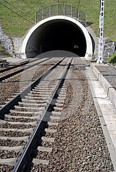 Railway and railroad track is goint into dark and long tunnel.