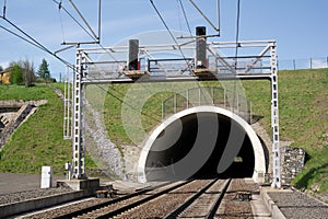 Railway and railroad track is goint into dark and long tunnel.