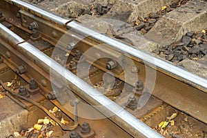 A railway with rails and concrete sleepers.Background of an old rusty railway.