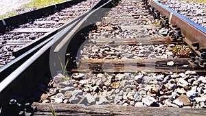 Railway. rails and old wooden sleepers close up. Rocky ground. Retro style