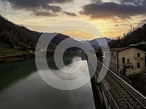 Railway with River, Sky and Vegetation, Tuscany, Italy