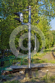 Railway semaphore on the background of foliage and trees