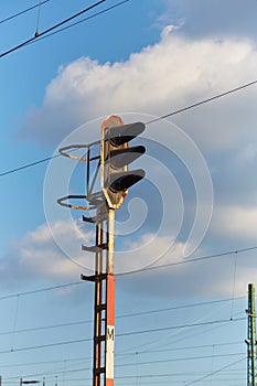 Railway signal light on a rusty post