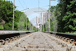 Railway in the spring forest city background. Beautiful landscape of railroad in summer forest