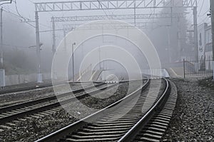 Railway station with an approaching fog.
