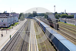 Railway station with freight cars on a summer day.