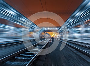 Railway station at night with motion blur effect. Railroad