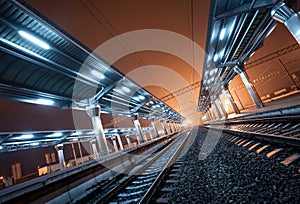 Railway station at night. Train platform in fog. Railroad