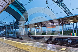 Railway station platform at evening time.