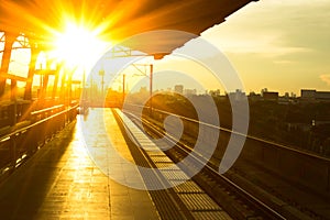 Railway station at platform in sunset