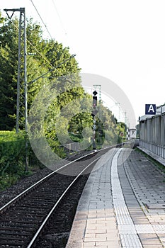 Railway station platforms with information signals and electricity transmission system to railroad.