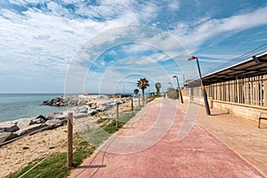 Railway station and road on waterfront by rocky beach