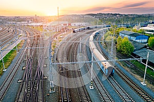 Railway station with wagons during sunrise from above. Reconstructed modern railway infrastructure