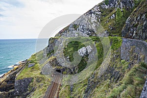 Railway through stone rocks mountain at Irish seacoast