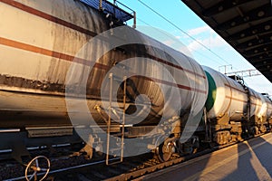 railway tank cars, railroad station platform, concept of freight transportation by rail, industrial cargo transport