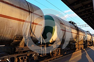 railway tank cars, railroad station platform, concept of freight transportation by rail, industrial cargo transport