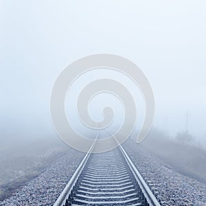 Railway to horizon in fog