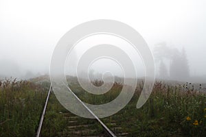 Railway to horizon in fog