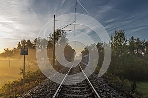 Railway track in color morning with fog and autumn color fresh air photo