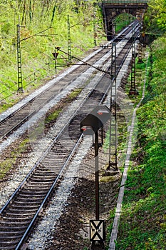 Railway track disappearing under a small bridge