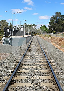 Railway track and platform with blue sky