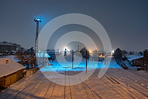 Railway tracks covered with snow at night