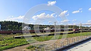 Railway tracks have been laid and electrified at the station with administrative buildings among the grassy lawns. There are train