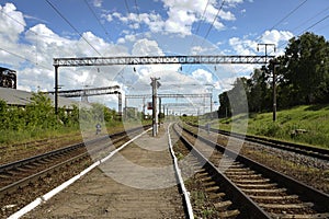 Railway tracks, passenger platform and overhead wiring in Topilly railway station in Russia, view towards Michurinsk.