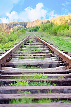 Railway tracks in a rural scene with nice blue sky