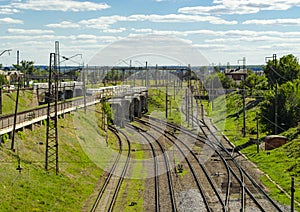 Railway tracks with switches and interchanges with Railway bridges. Wires and electric posts. High angle view with perspective.