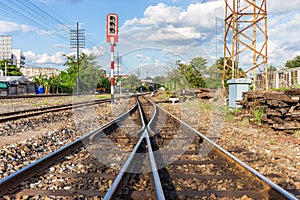 Railway tracks with traffic lights in countryside