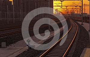 Railway Tracks At Train Station During Sunset