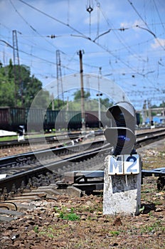 Railway traffic light semaphore against the background of a day railway landscape. Signal device on the railway trac