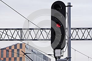 Railway traffic lights for trains near the railway and electric wires. Regulation of railway transport