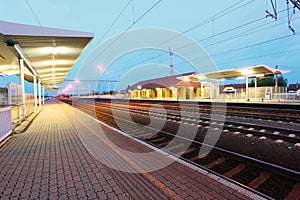 Railway with train platform at night photo