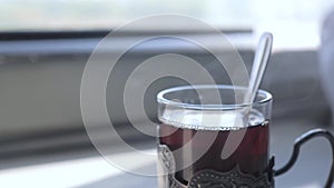 Railway travel concept. tea with a spoon in a glass glass vintage old lifestyle stands on a table in a train carriage