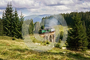 Railway viaduct bridge in Ukraine with the steam train photo