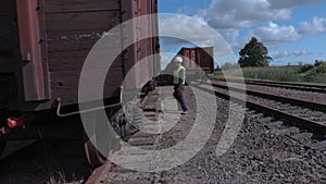 Railway worker inspecting wagons