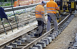 Railway workers bolting track rail.