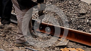 Railway workers bolting track rail