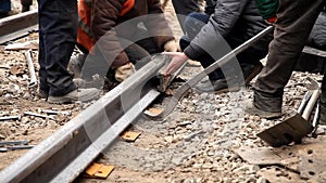 Railway workers bolting track rail