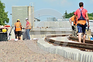 Railway Workers repairing railway on hot summer day