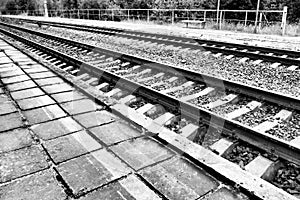 Railways. Metal steel rails and wooden sleepers. Rivets and fasteners on the railroad. Stony backfill of railway tracks