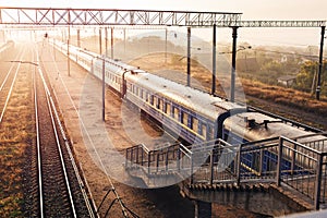 Railways with passenger trains beautifully lit by setting sun