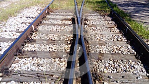 railways. Rails and sleepers on the ground near the station. Long way concept. Interlacing of tracks, railway arrows.