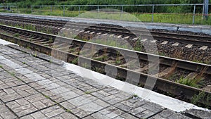 railways. Rails and sleepers on the ground near the station. Long way concept. Interlacing of tracks, railway arrows