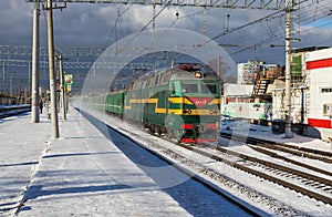 Railways Train passes by the city platform Ramenskoye in the Moscow Region in the winter