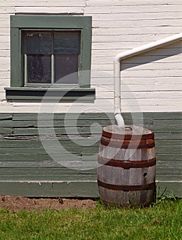 Rain barrel beside nineteenth century building photo