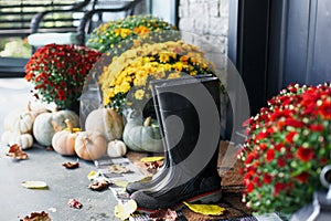 Rain Boots on Front Porch Decorated for Autumn