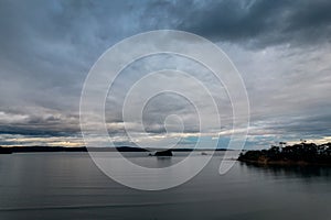 Rain clouds and aerial reverse sunset seascape at Corrigans Beach